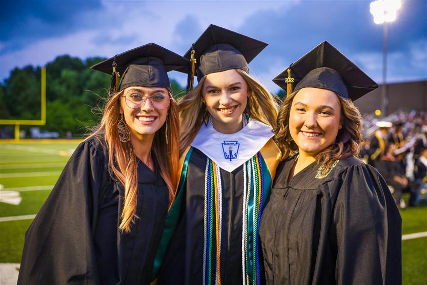 Students graduate on a football field